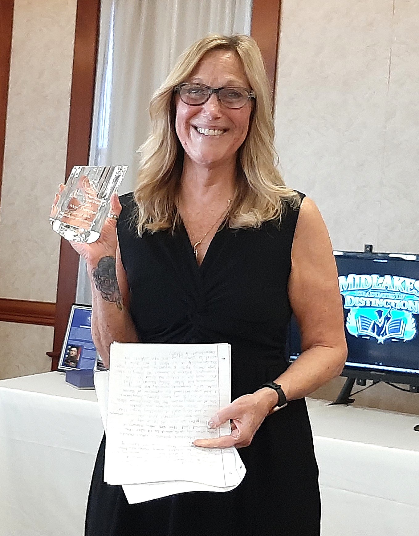 Mary receiving Midlakes Graduate of Distinction award
