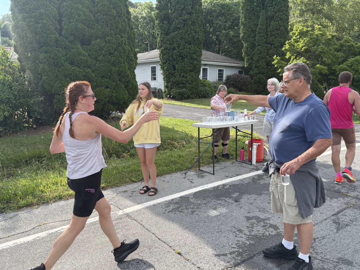 Club members providing water to runners at the Sauerkraut Festival