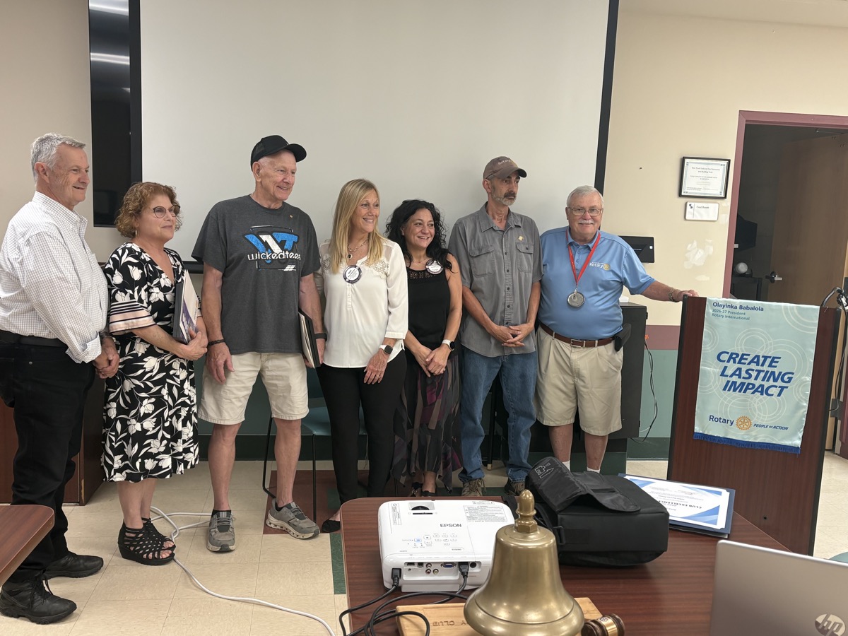 Induction of new members Hope Galens and Ron at a club meeting