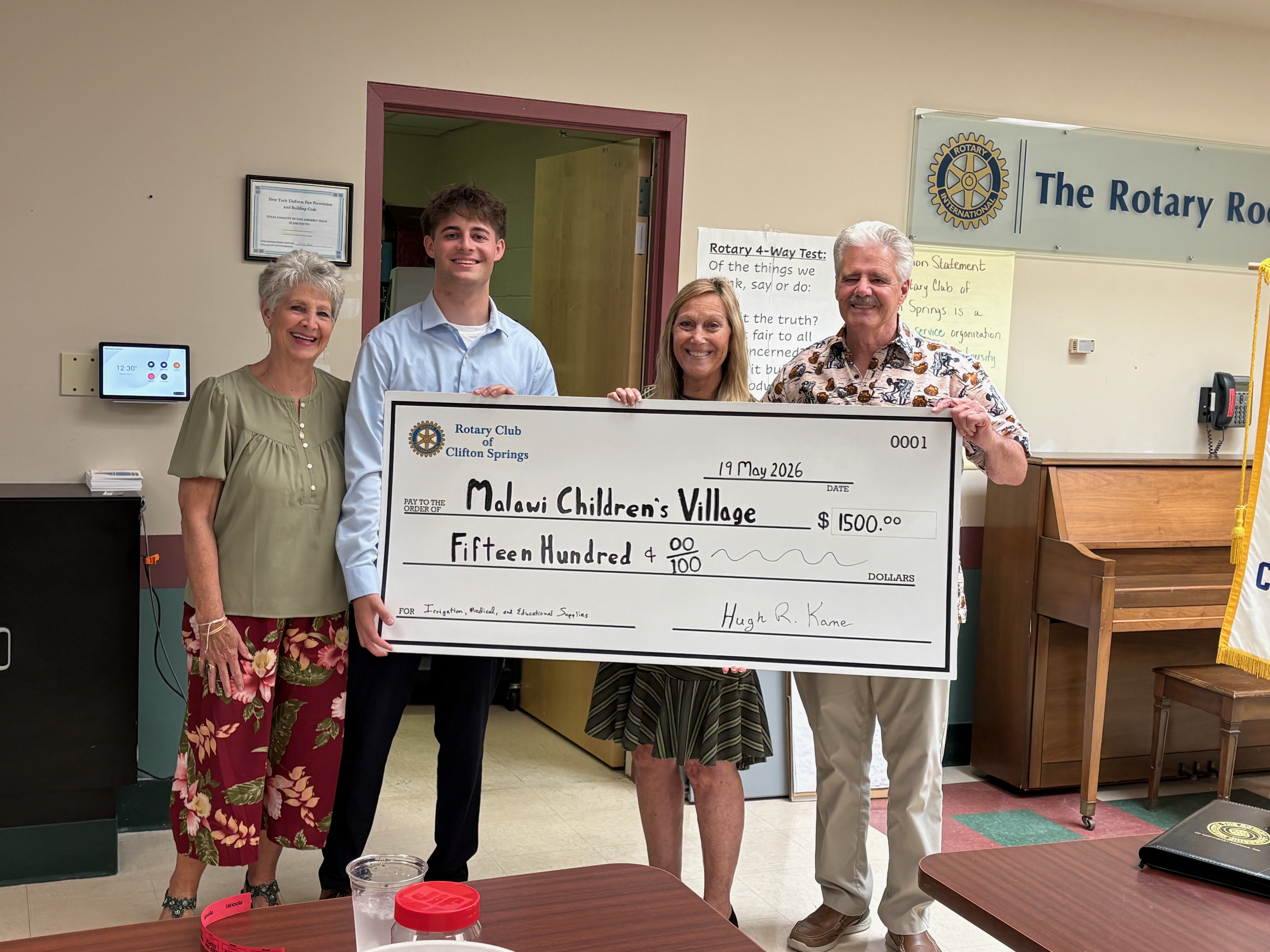 Club members presenting a $1,500 check to the Malawi Children's Village